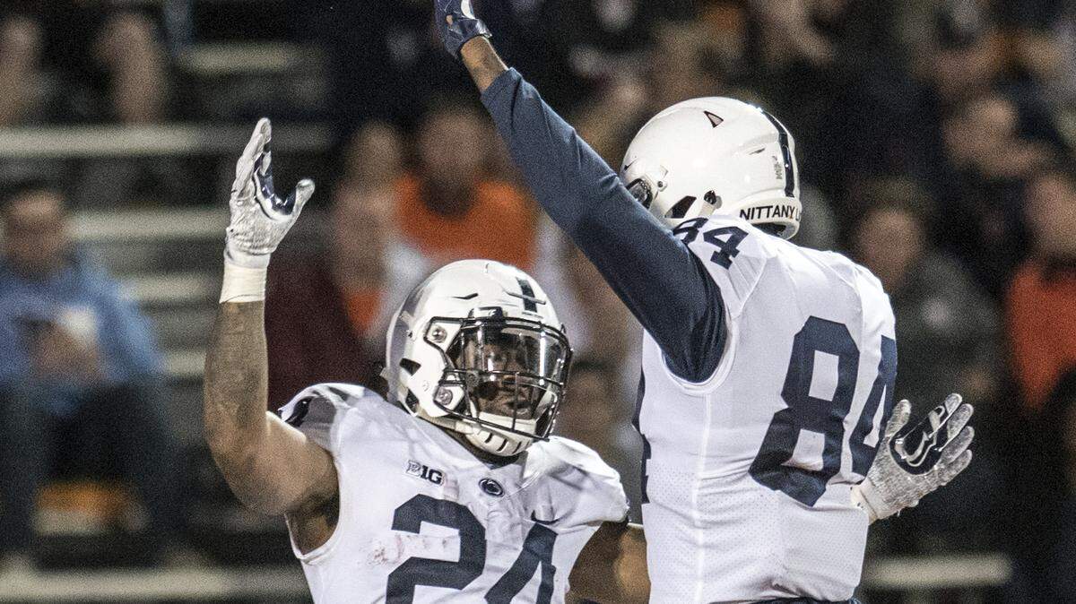 Penn State’s Miles Sanders (24) and Juwan Johnson (84) celebrate a touchdown during the second half of an NCAA college football game against Illinois on Friday, Sept. 21, 2018, in Champaign, Ill. (AP Photo/Holly Hart)