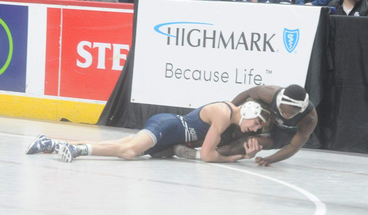Philipsburg-Osecola’s Caleb Hummel finishes off a takedown of Montgomery’s Manny Stoltzfus in their 107-pound preliminary match of the PIAA Class 2A Championships on Thursday, March 9, 2023 at the Giant Center in Hershey. Hummell beat Stoltzfus, 14-3.