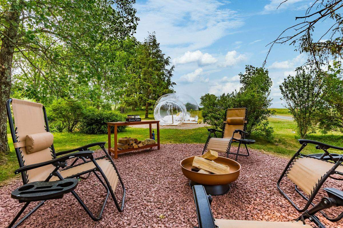 There’s an outdoor seating and s’mores station outside the stargazing bubble tent at the Airbnb.