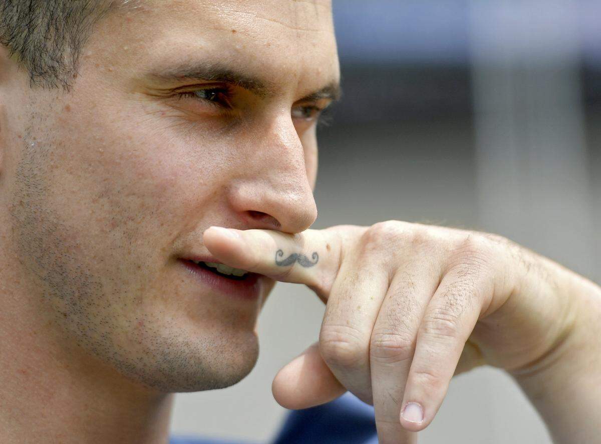 Penn State defensive end Evan Schwan shows of his mustache tattoo during media day on Thursday, Aug. 4, 2016 at Beaver Stadium.  