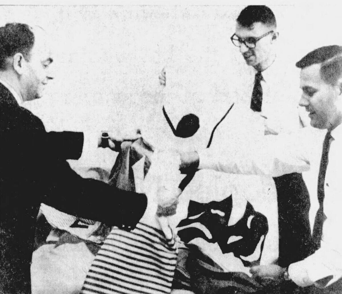 Decorations chairman Guy Kresge, far left, sorts through a stack of submitted 7-foot banners by area residents alongside Lynn Miller and Harold Johnson during the first-ever Central Pennsylvania Festival of the Arts in July 1967.
