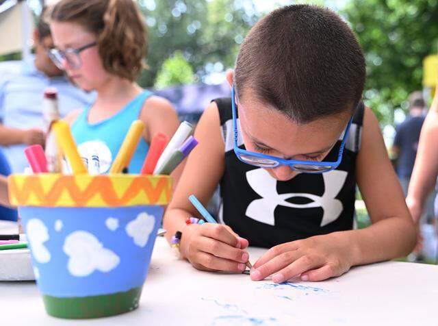 Hudson Rebar 6 (right) and Quinn Rebar, 8, of Ramey, Pa., color animals during Wednesday’s Children and Youth Day at the 57th Central Pennsylvania Festival of the Arts in State College.