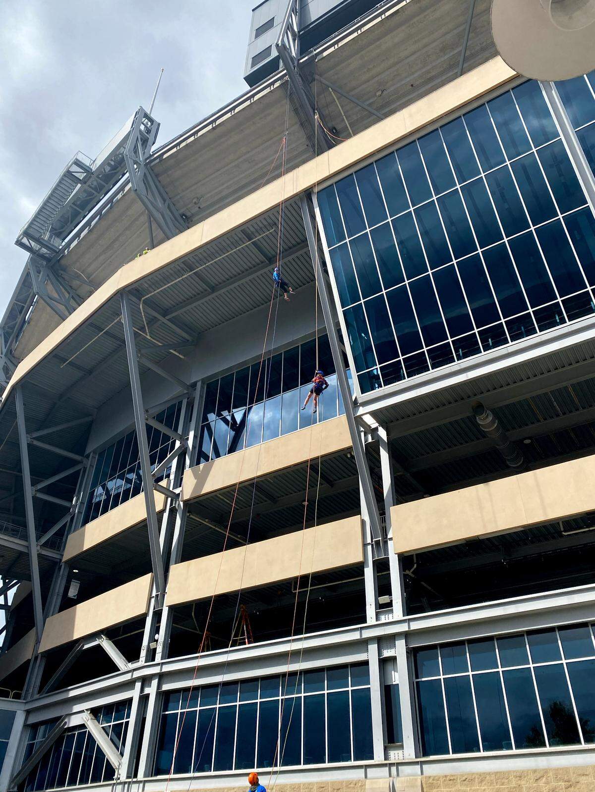 Centre Daily Times photographer Abby Drey rappels at Beaver Stadium with Faye Chadwell, The Penn State United Way campaign chair on Monday, Oct. 7, 2024.