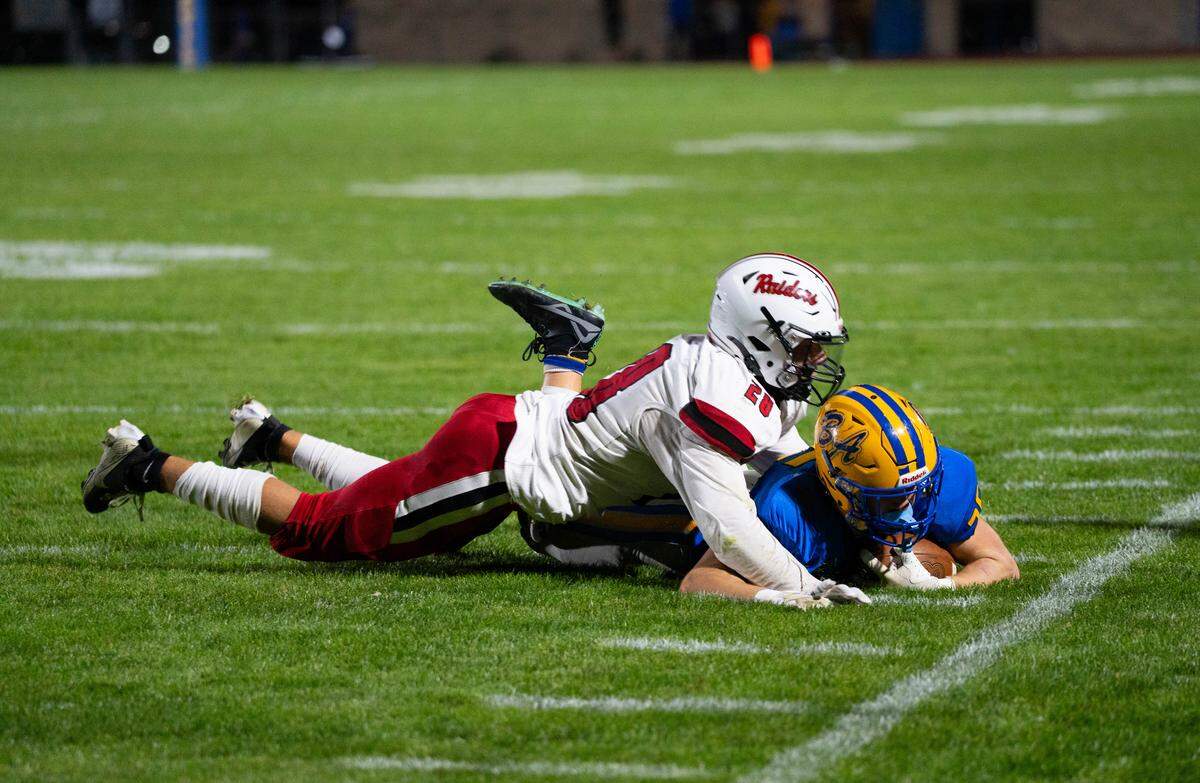 Bellefonte senior Jackson Long, left, tackles junior Chase Plummer during a Friday night football game against Bellwood-Antis in Bellwood, Pa., on Oct. 17, 2025. The Blue Devils beat the Red Raiders 22-0.