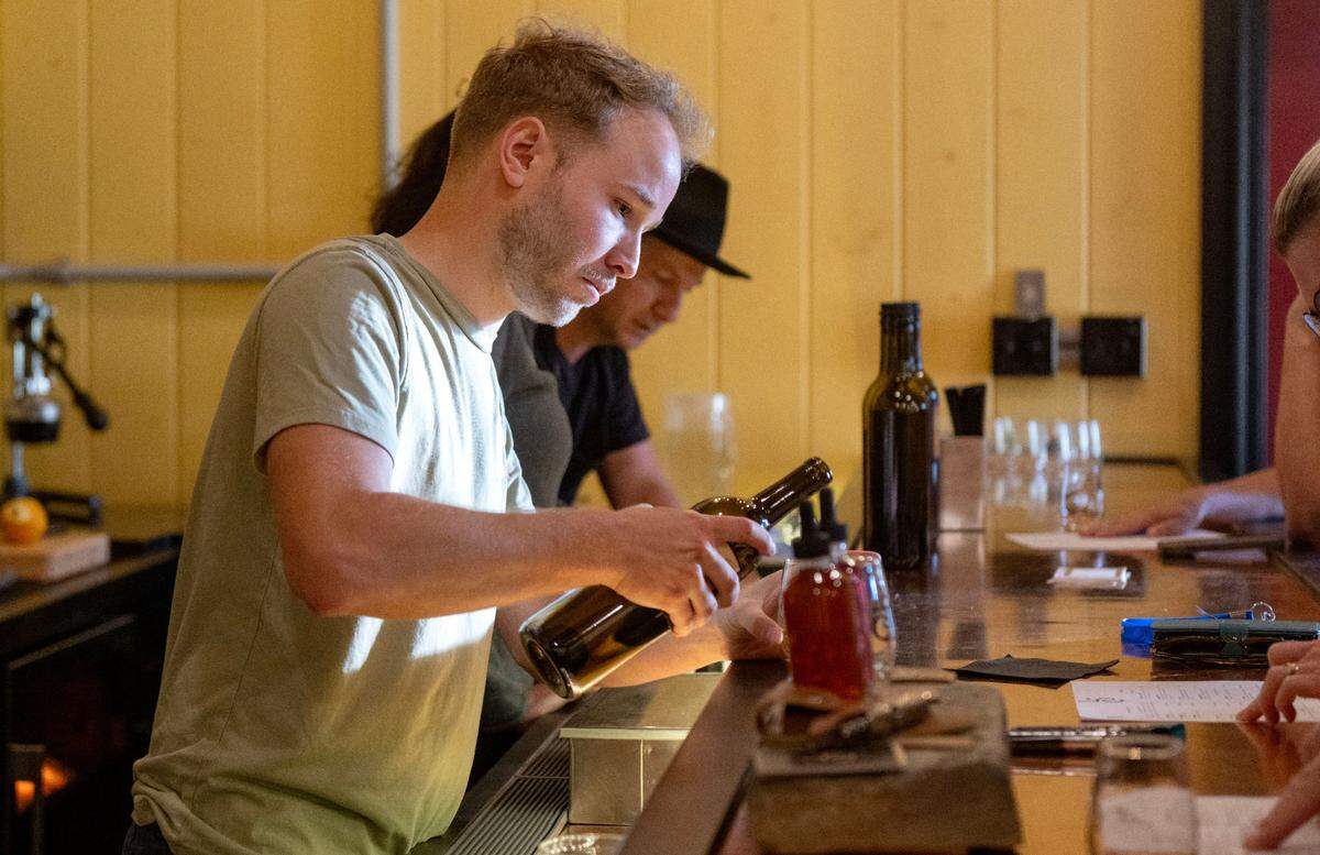 Drew Sterner pours a class of cider at Laurel Spring Cidery on Thursday, July 17, 2025.