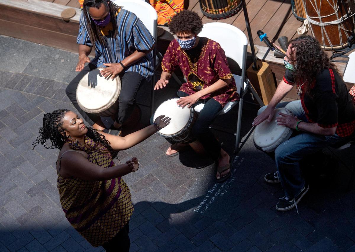 Joy Roberston dances as members of Roots of Life play during the inaugural Juneteenth celebration hosted by the State College NAACP at MLK Plaza in State College on Friday, June 19, 2020.
