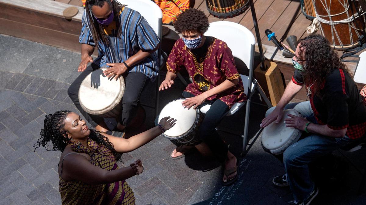Joy Roberston dances as members of Roots of Life playing during the inaugural Juneteenth celebration hosted by the State College NAACP at MLK Plaza in State College on Friday, June 19, 2020.