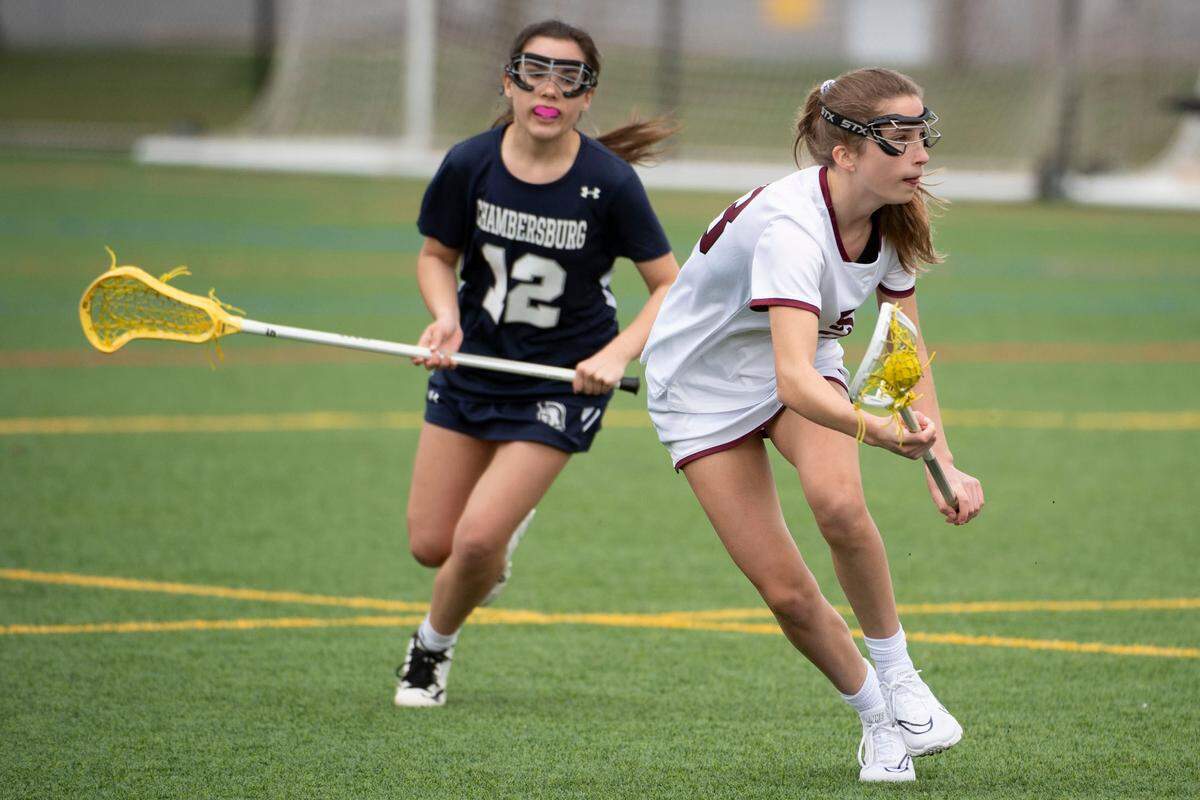 State College’s Sydney O’Donnell runs past a defender during a PIAA lacrosse game between State High and Chambersburg on Thursday, April 15, 2022 in State College, Pa.