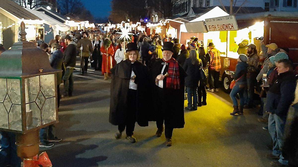 Garrett Franck and Larry Mitchell, “town crier,” cleared the way for a procession at the opening of the Mifflinburg Christkindl Market.