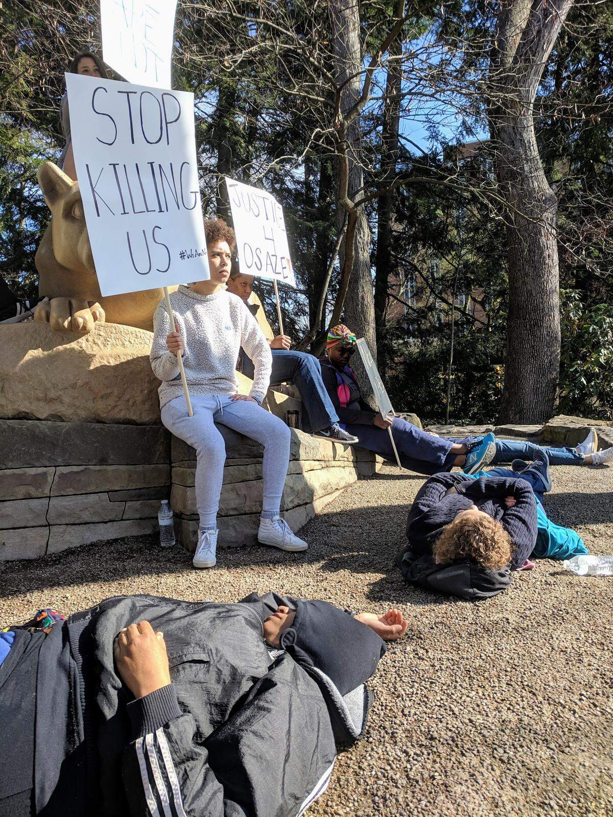 The group calling itself #WeAreNot staged a silent protest and die-in in front Penn State’s Lion Shrine on Saturday, ahead of the Blue-White Game. The group organized in the wake of the fatal officer-involved shooting of State College resident Osaze Osagie on March 20.
