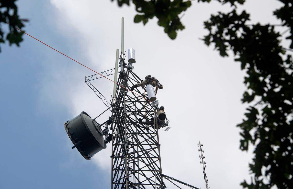 A crew from Centre Communications and Mains Technology Solutions helps to install a sector antenna for Centre WISP Venture Company on Wednesday on Centre Hall mountain.