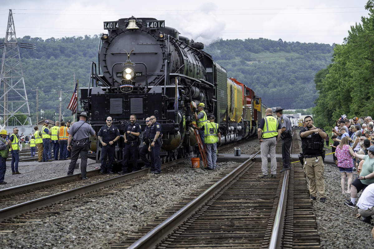 Police officers pose in front of the locomotive during its Lewistown whistle stop.