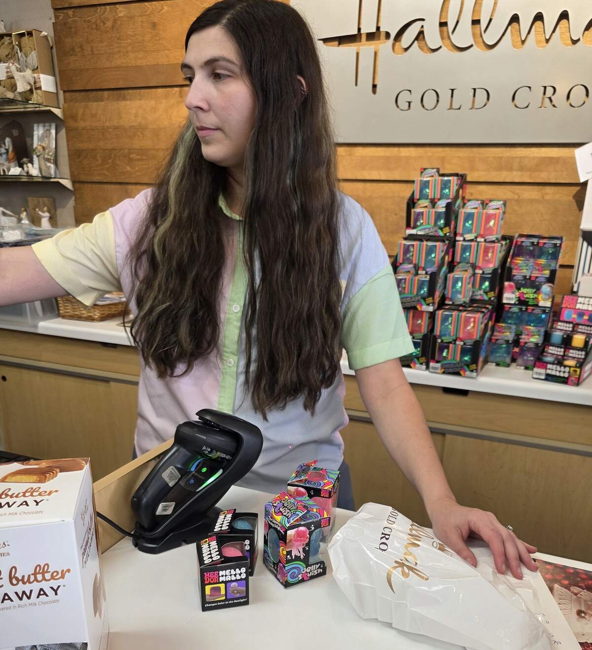 Hallmark employee Katie Peters rings up a customer’s NeeDoh purchase on Thursday, June 11, 2026.