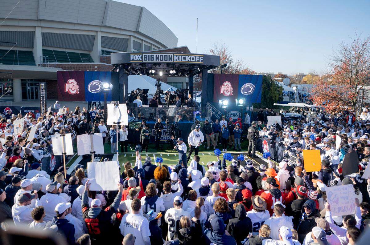 Fans cheer as and hold up signs for Fox Big Noon Kickoff Show outside of Beaver Stadium on Saturday, Oct. 29, 2022.