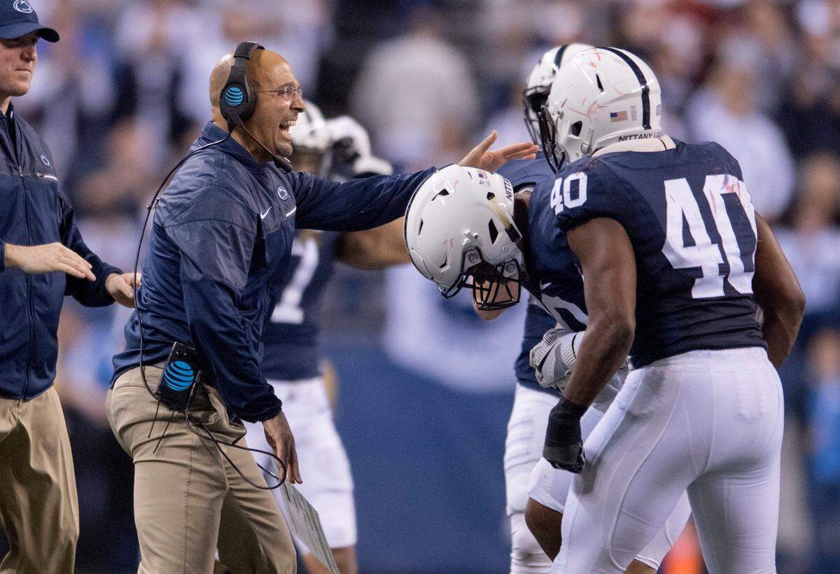 Penn State football coach James Franklin congratulates the defensive line as they come off the field after stopping Wisconsin during the Big Ten Championship game on Saturday, December 3, 2016 at Lucas Oil Stadium.