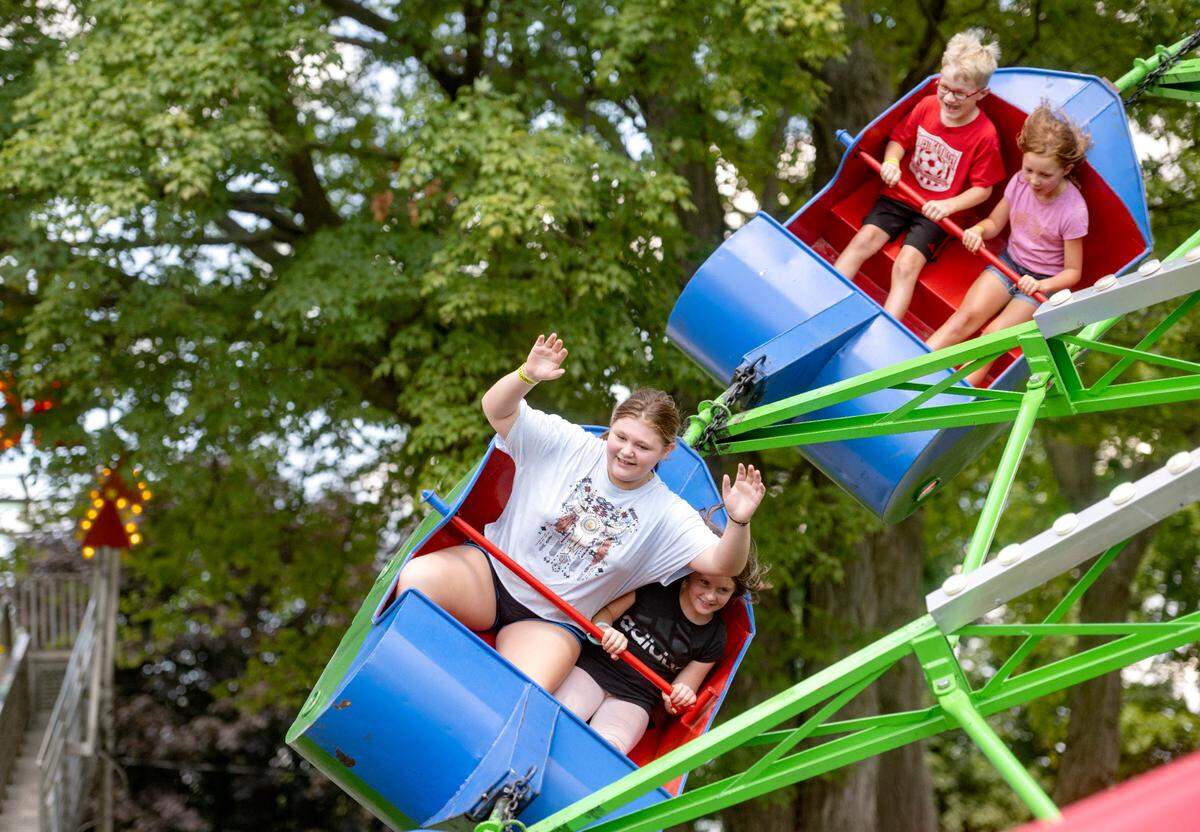 Kids enjoy the ride by Garrick Amusement on the first day of the Centre County Grange Fair on Friday, Aug. 19, 2022.
