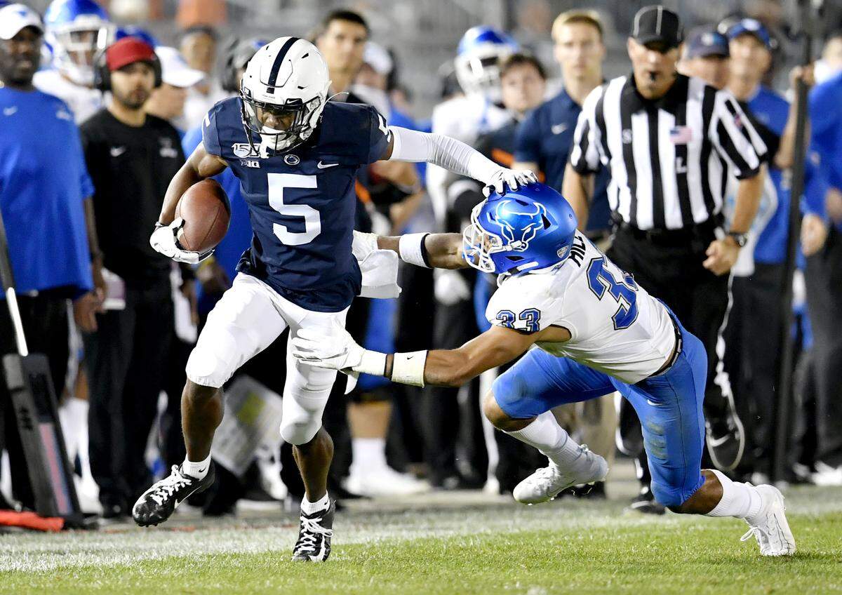 Penn State wide receiver Jahan Dotson runs down the field with the ball from Buffalo’s Tyrone Hill during the game on Saturday Sept. 7, 2019.