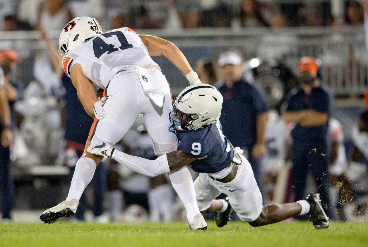 Penn State cornerback Joey Porter Jr. stops Auburn’s John Samuel Shenker during the game.