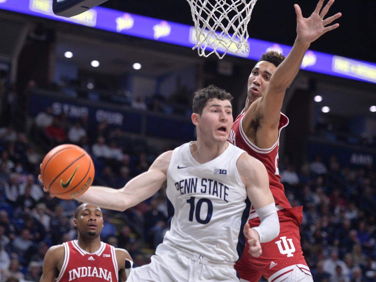 Penn State’s Andrew Funk (10) passes around Indiana’s Trayce Jackson-Davis (23) during the first half of an NCAA college basketball game Wednesday, Jan. 11, 2023, in State College.