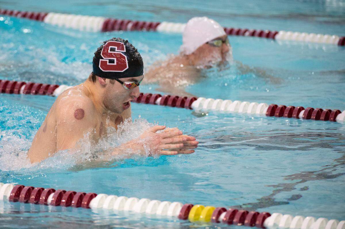 State College’s Shawn Erdley and State College’s Garrick Zheng race during the PIAA Swimming and Diving District VI AAA Championships at State College Area High School on Friday, March 5, 2021 in State College, PA.