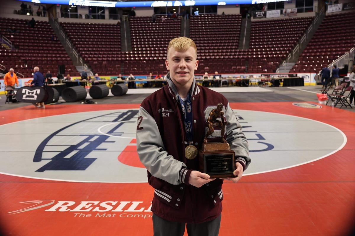 State College’s Pierson Manville poses with the Outstanding Wrestler award as he claimed that for beating two returning state champions on way to his first PIAA crown.