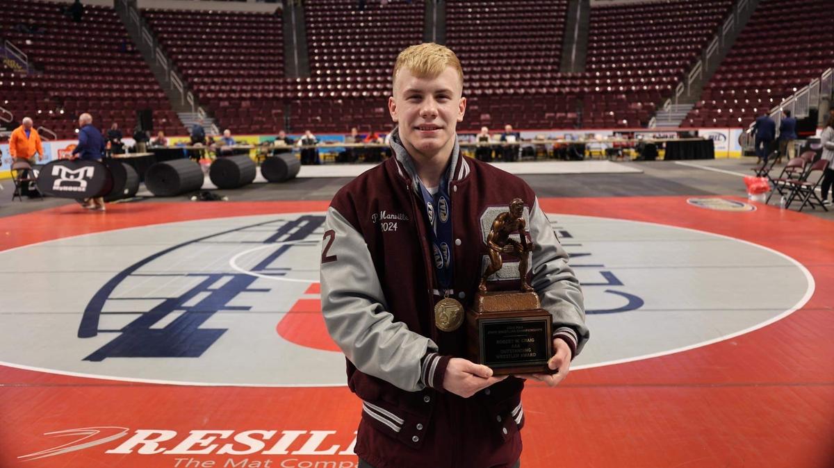 State College’s Pierson Manville poses with the Outstanding Wrestler award after defeating two returning state champions on way to his first PIAA crown.