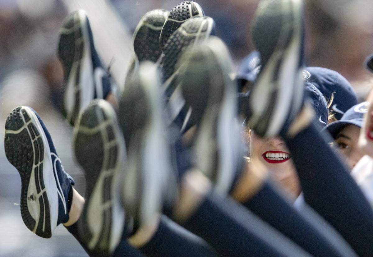 The Lionettes smile as they do a kick line during their performance at the Blue-White game on Saturday, April 23, 2022.