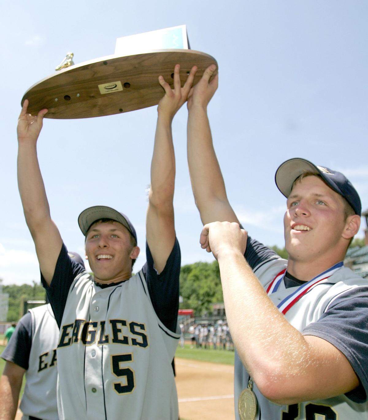 Bald Eagle’s Ryan MacNamara and Brian Kochik hoist the PIAA Class AA baseball championship trophy.