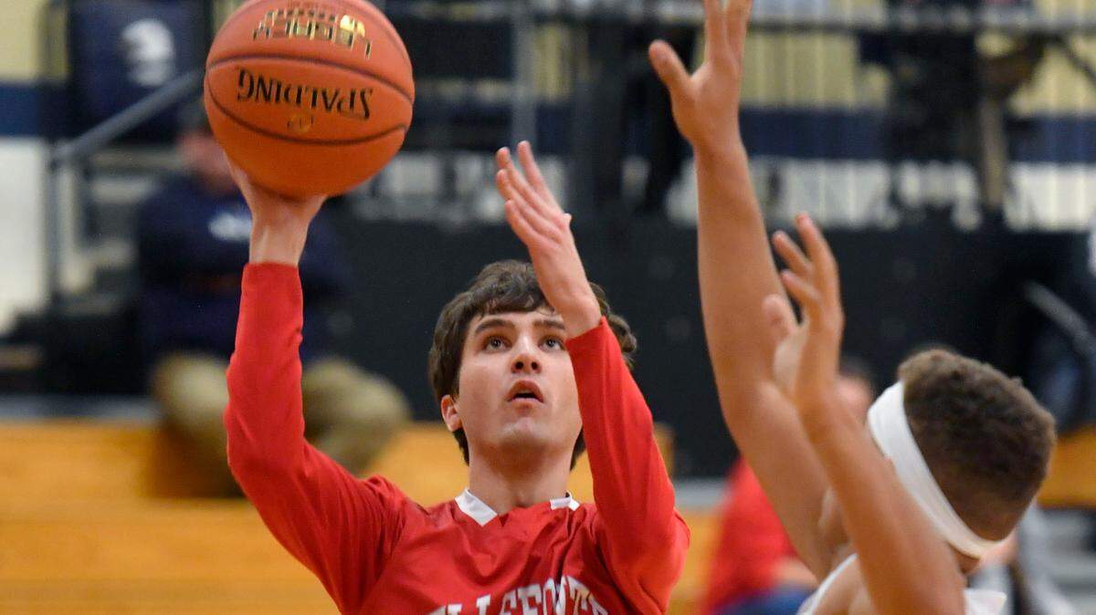Bellefonte’s Gannon Brungard shoots for a basket over Bald Eagle Area defenders during the game on Tuesday, Jan. 18, 2022.