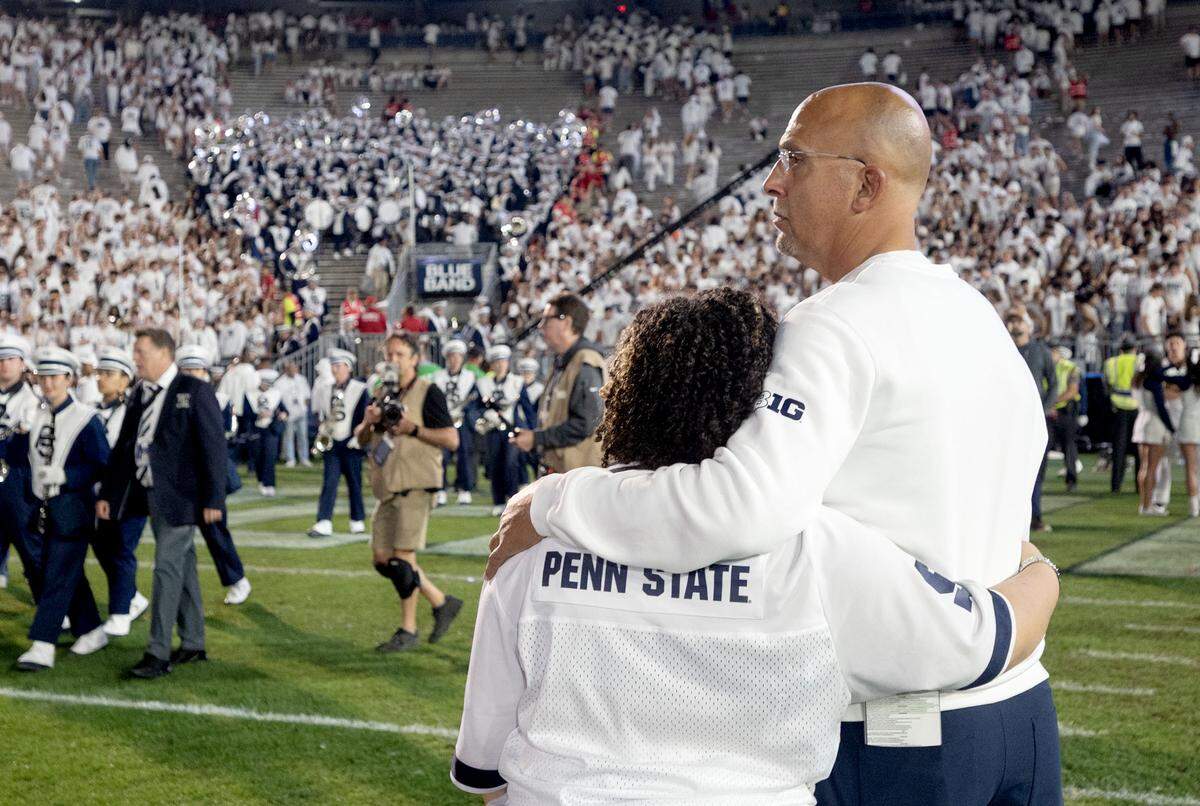 Penn State football coach James Franklin stands with his arms around his daughter after the loss to Oregon on Saturday, Sept. 27, 2025.  