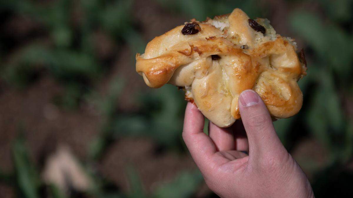 Skye Chang, owner of Chew Chew Bun: Asian Bakery, holds a baked good on April 6, 2021 at the Penn State Arboretum in State College, Pa.