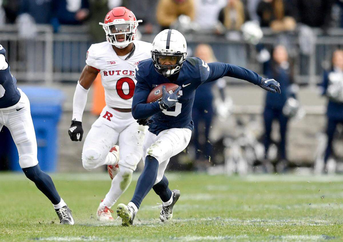 Penn State wide receiver Jahan Dotson runs down the field with the ball from Rutgers defenders during the game on Saturday, Nov. 20, 2021.