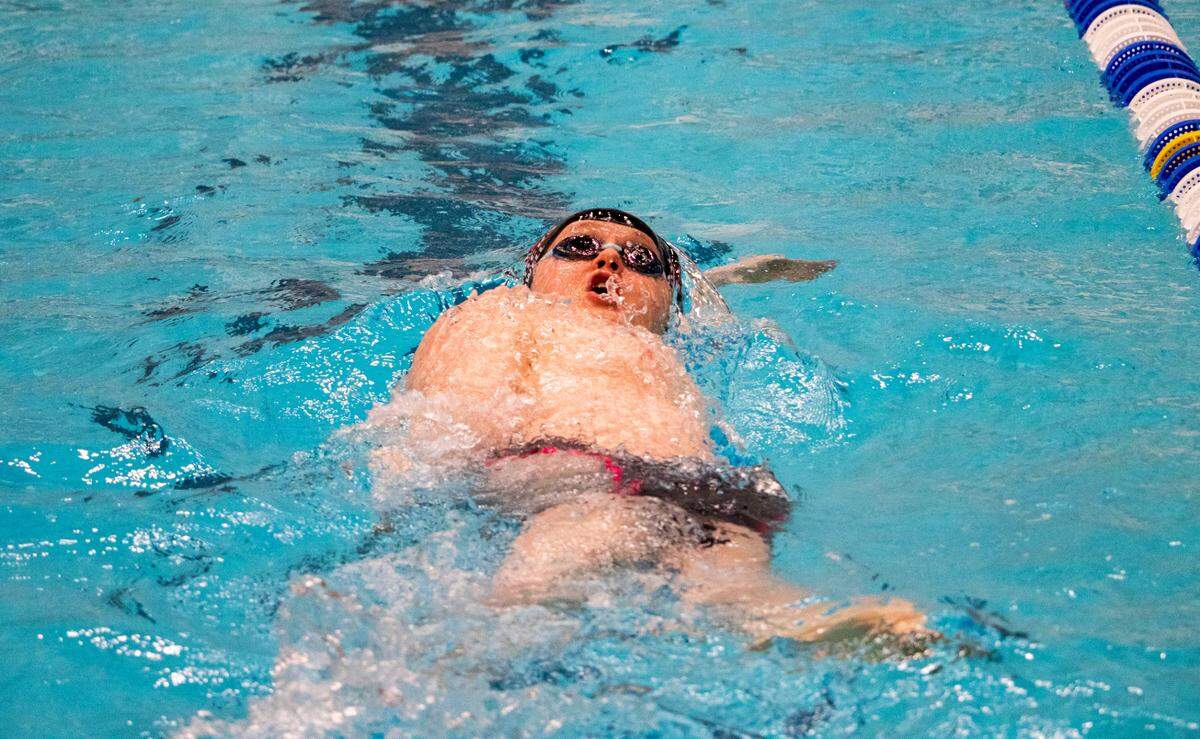 Bellefonte Area High School junior Cedric Bagwell surfaces for air during the Boy’s 100 Yard Back Stroke in the AA Bracket during the PIAA Swimming and Diving 2023 District 6 Championship held at the McCoy Natatorium on Saturday, Mar. 4, 2023, in University Park, Pa. Bagwell placed seventh in his event with a final time of 1:03.98.