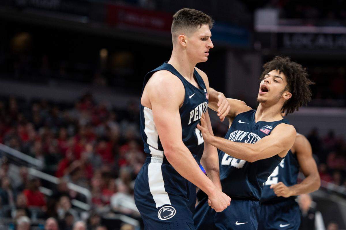 Penn State forward John Harrar (21) and Penn State guard Dallion Johnson (23) celebrate during a NCAA basketball game between Penn State and Ohio State in the Big Ten men’s basketball tournament at Gainbridge Fieldhouse on Thursday in Indianapolis, Ind.