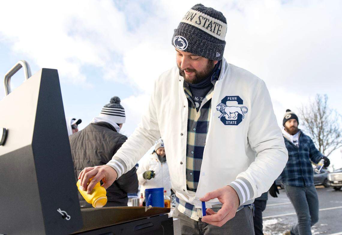 Jake Prohaska cooks some pancakes as he tailgates with family and friends outside of Beaver Stadium before the CFP first round game between Penn State and SMU on Saturday, Dec. 21, 2024.
