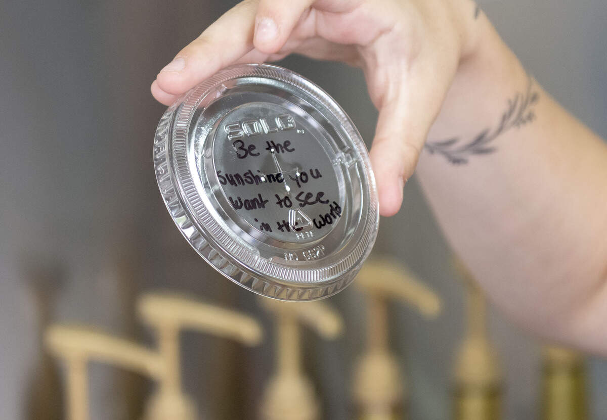 Alexa Cowher of Joelle’s Sip & Bites holds a drink cup with a message written on it. Cowher writes messages on all the lids to brighten her customers day.