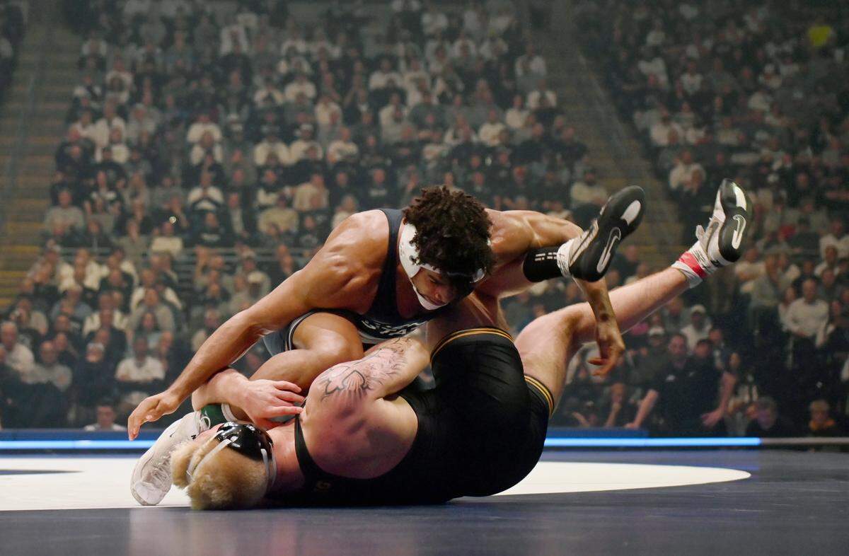 Penn State’s Carter Starocci controls Iowa’s Angelo Ferrari in the 184-pound bout of the match on Friday, Jan. 31, 2025 at the Bryce Jordan Center. Starocci won by decision, 2-1.