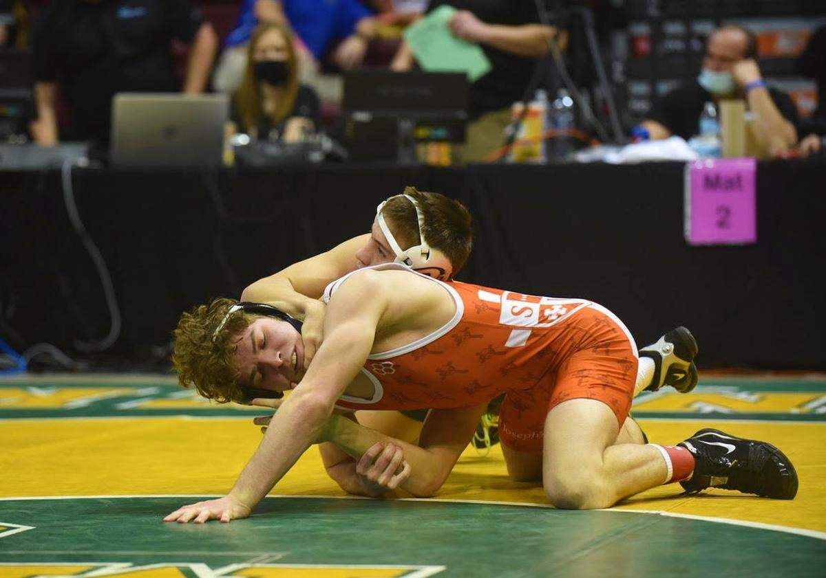 St. Joseph’s Catholic Academy’s Zack Witmer aims to escape from Forest Hills’ Jackson Arrington in their 132-pound finals match during the PIAA Class 2A Southwest Regional tournament. Arrington pinned Witmer in 3:57 to win the title.