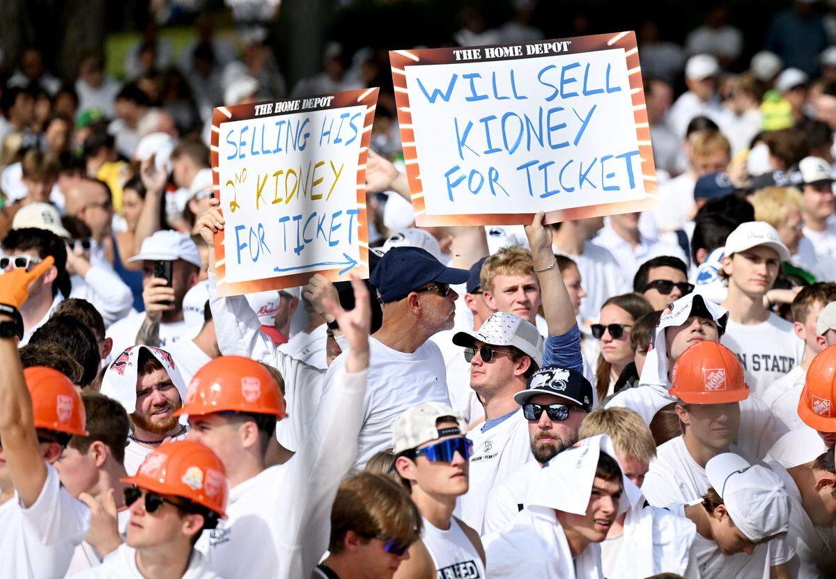 Fans hold up signs during ESPN’s College GameDay as it films at Penn State on Saturday, Sept. 27, 2025.  