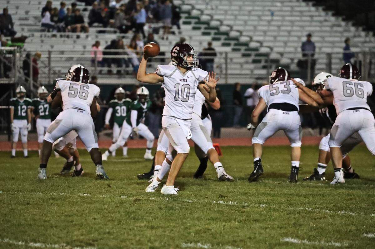 State College QB Brady Dorner looks for a pass against Carlisle on Sept. 13.