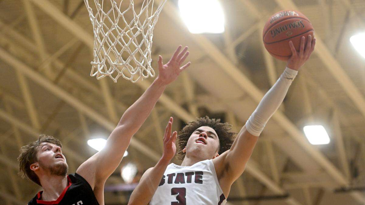 State College’s Braeden Shrewsberry gets a basket around Cumberland Valley’s Nolan Gilbert during a game on Feb. 7. The Little Lions were defeated Saturday in the PIAA quarterfinals.