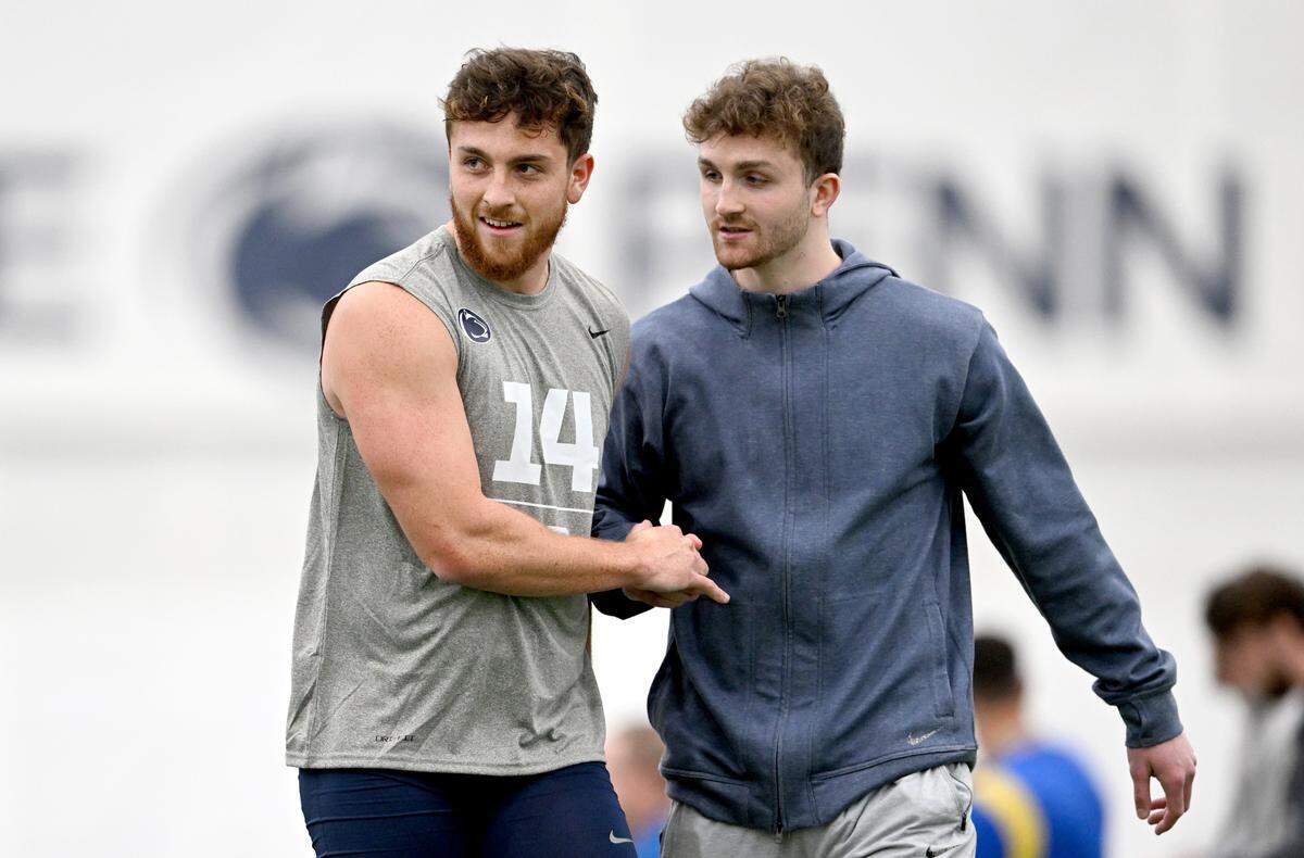 Quarterback Sean Clifford walks with his brother Liam Clifford during Penn State football’s Pro Day on Friday, March 24, 2023.
