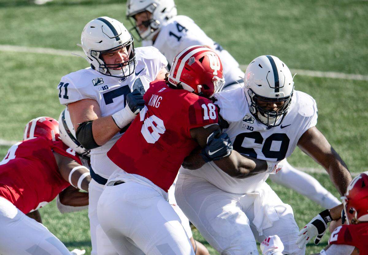 Penn State offensive lineman Will Fries and CJ Thorpe block an Indiana defender during the game on Saturday, Oct. 24, 2020 at Memorial Stadium.