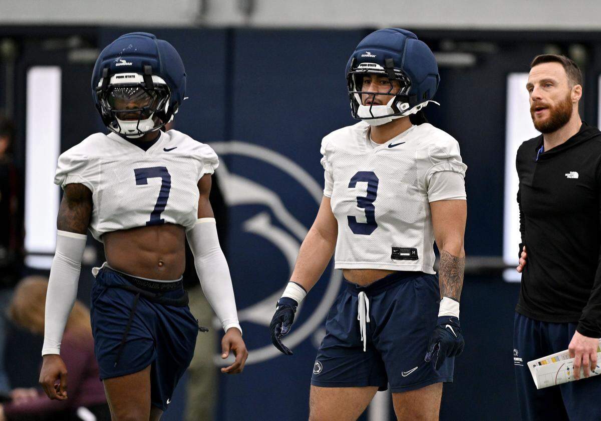 Penn State cornerback Zion Tracy and safety Jamison Patton listen to instructions during spring practice on Thursday, March 26, 2026.