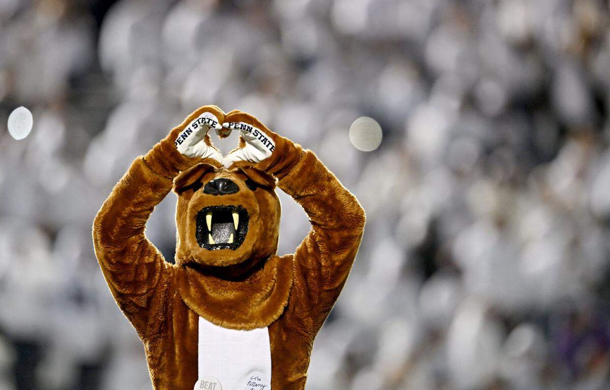 The Penn State Nittany Lion makes a heart with his hands to the crowd during the White Out game against Washington on Saturday, Nov. 9, 2024.  