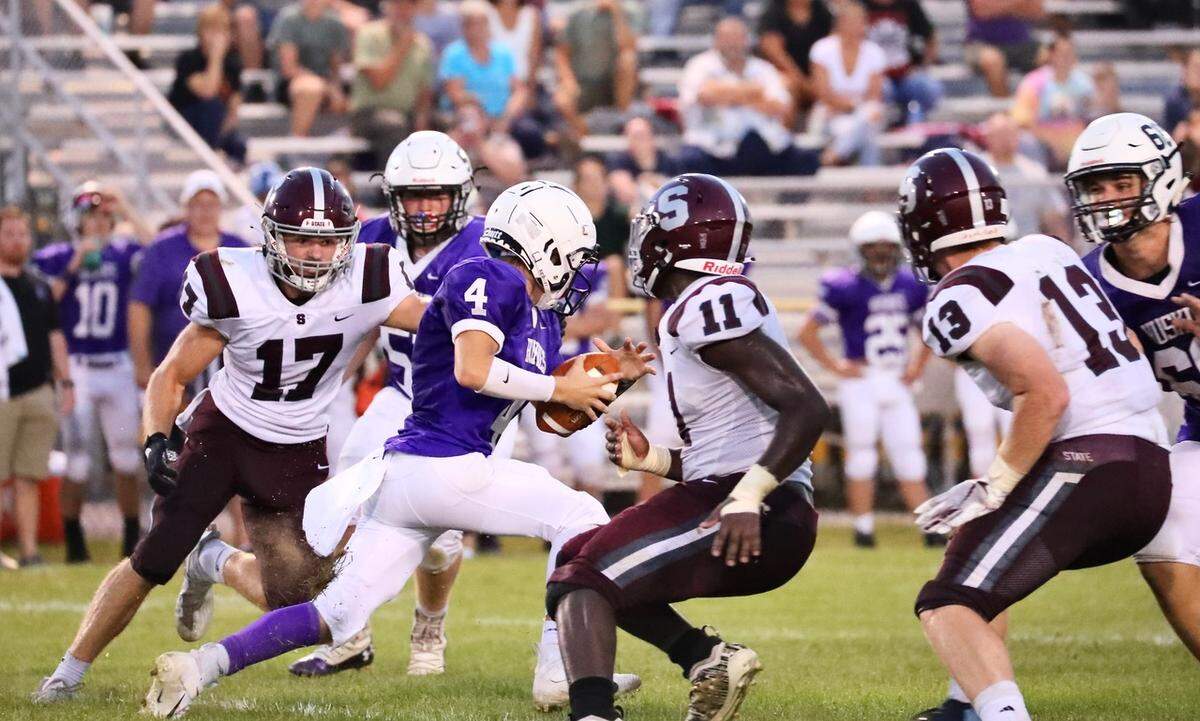 State College’s Kyle Kurzinger (17) and John Scott (11) look to stop the Mifflin County ball carrier on Friday, Aug. 27, 2021, in Lewistown. State College won, 51-6.