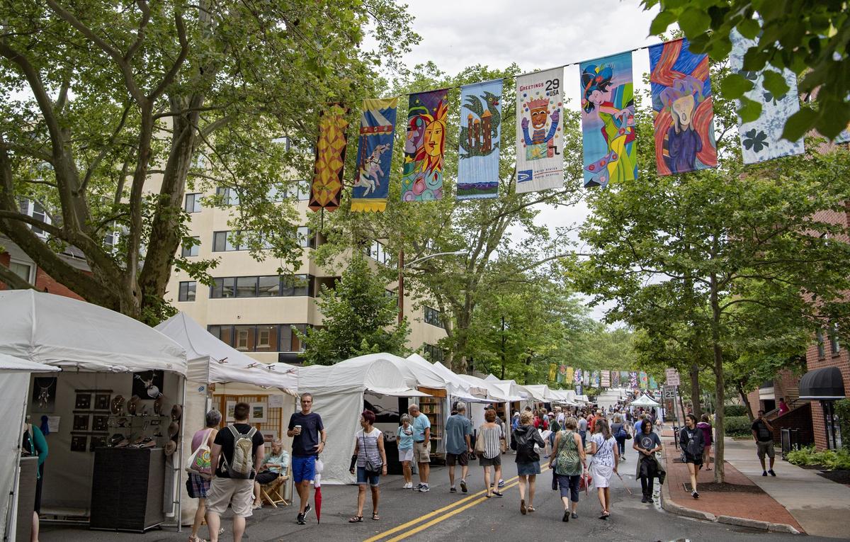 Visitors walk along the sidewalk sale at the Central Pennsylvania Festival of the Arts on Thursday, July 11, 2019.