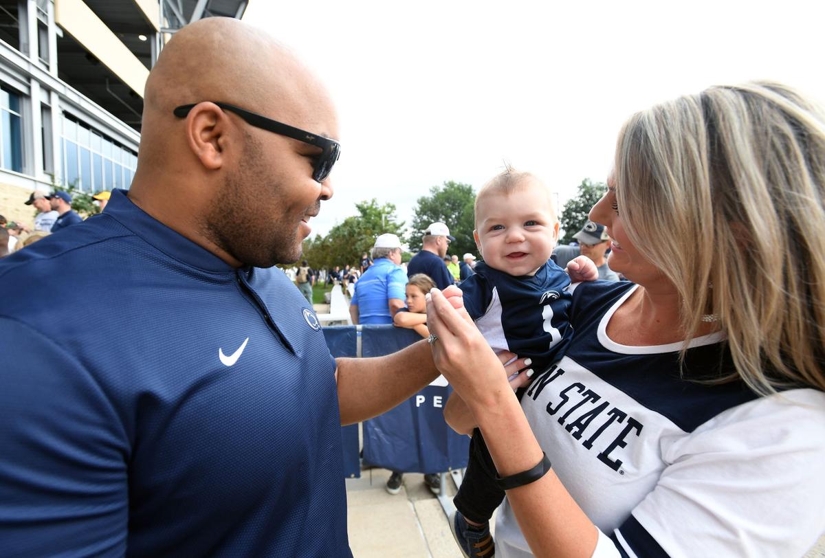 Chelsea Newsock holds her son, Braeson Newsock, five months, and greets Kenny Sanders Saturday, Sept. 15, 2018 at Beaver Stadium.