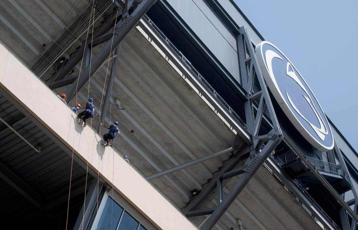 Mary Potter and Christa Hosterman start their rappel from Beaver Stadium for the Centre County United Way Over the Edge fundraiser on Friday, May 19, 2023.