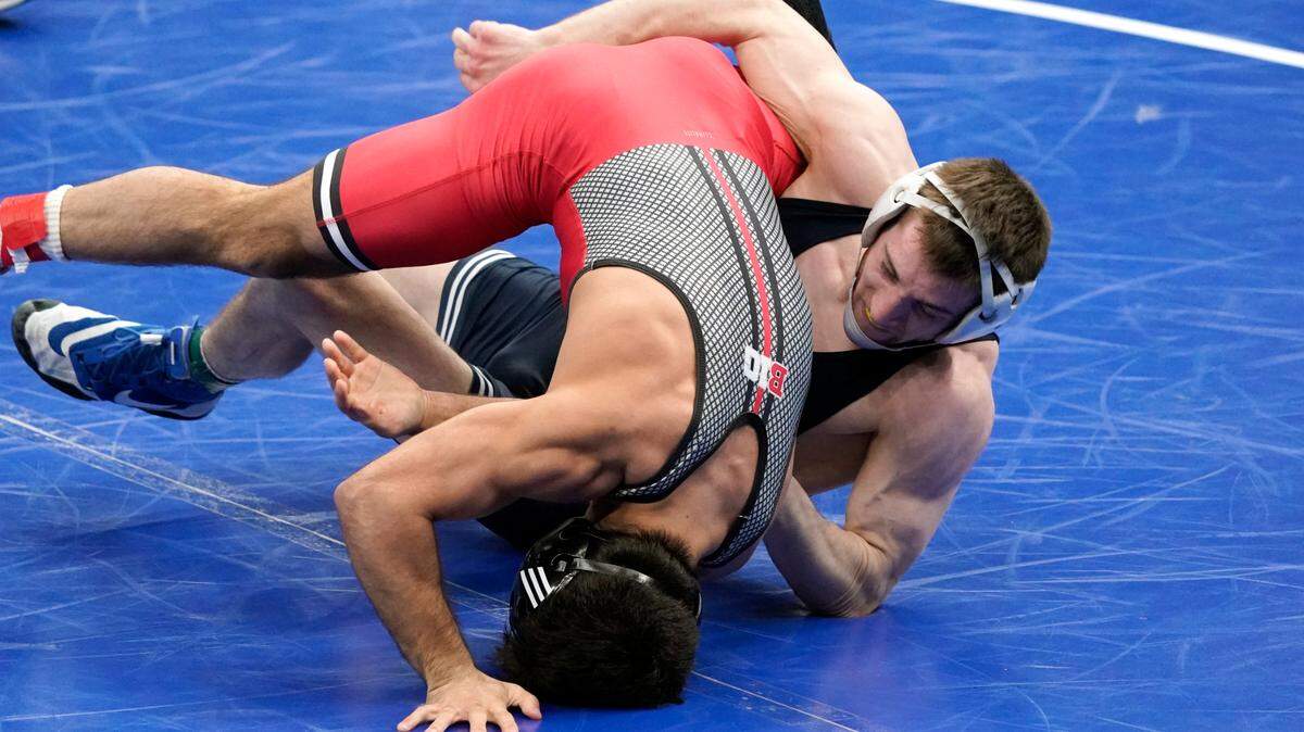 Rutgers’ Sebastian Rivera takes on Penn State’s Nick Lee, right, during their 141-pound match in the semifinal round of the NCAA wrestling championships Friday, March 19, 2021, in St. Louis. (AP Photo/Jeff Roberson)
